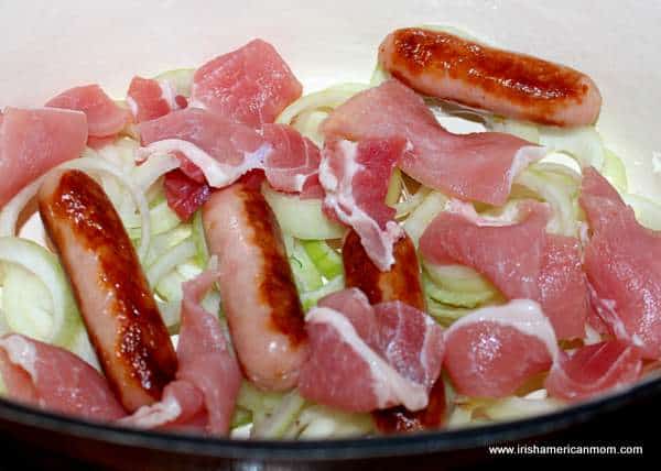 Layering ingredients for Dublin Coddle | Irish American Mom layes of rashers, sausages, onions and potatoes for coddle recipe