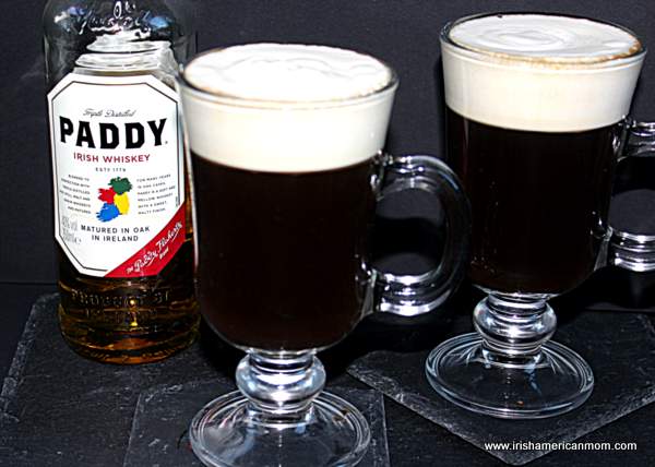 Paddy whiskey from Cork used to make Irish coffees | Irish American Mom A bottle f Irish whiskey beside two Irish coffees
