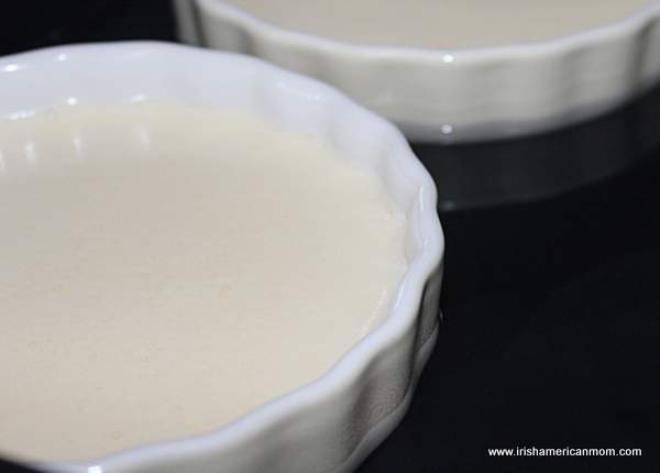 Adding water to a baking pan to make a bain maire | Irish American Mom A ramekin filled with custard mixture