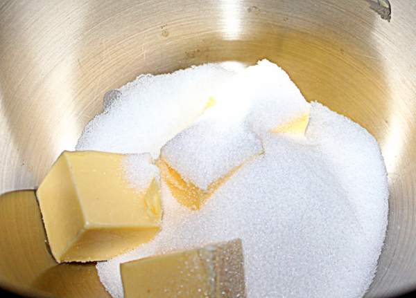 Creaming butter and sugar for Eve's Pudding | Irish American Mom Butter in cubes with sugar in a large silver mixing bowl.