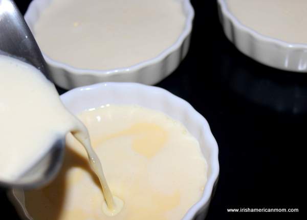 Pouring custard mix into ramekins for Baileys creme brulee | Irish American Mom Pouring a custard mixture into a ramekin