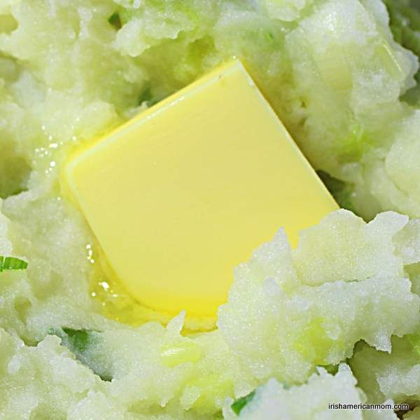 Butter melting in Irish champ | Irish American Mom A knob of butter melting on champ or Irish mashed potatoes with green onions