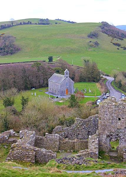 View of the old country church beside the Rock of Dunamase in County Laois Ireland | Irish American Mom Looking down on a stone church from a ruined castle on a hill