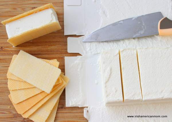 Making ice cream sandwiches Irish style | Irish American Mom A block of ice cream with two slices cut beside vanilla wafers, an ice cream sandwich and a knife