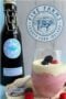 Glass of berry mousse beside a bottle of Irish cream