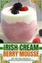 Glass dessert filled with pink berry mousse topped with whipped cream, blackberries, and raspberries, with text banner promoting an Irish cream berry mousse recipe.