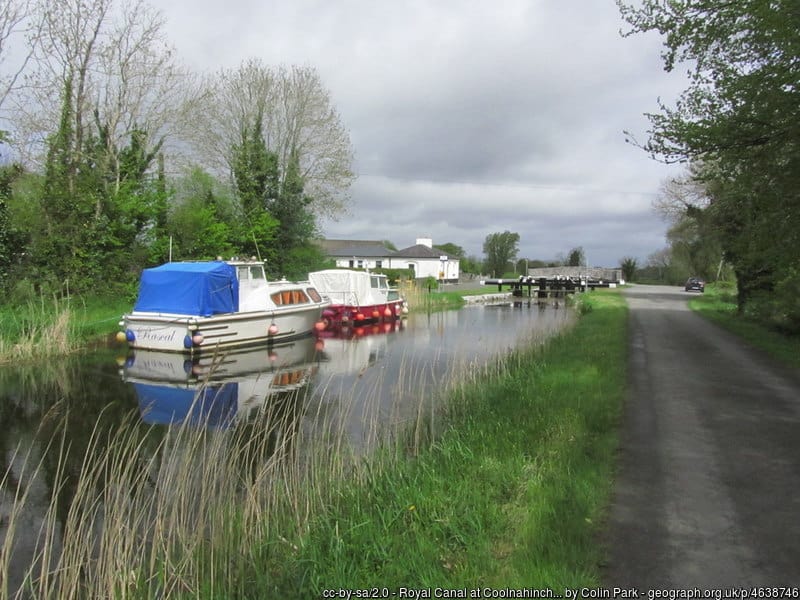 Boats moored to the side of a river