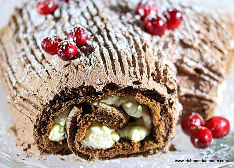 A close up of a piece of chocolate cake on a plate with whipped cream filling