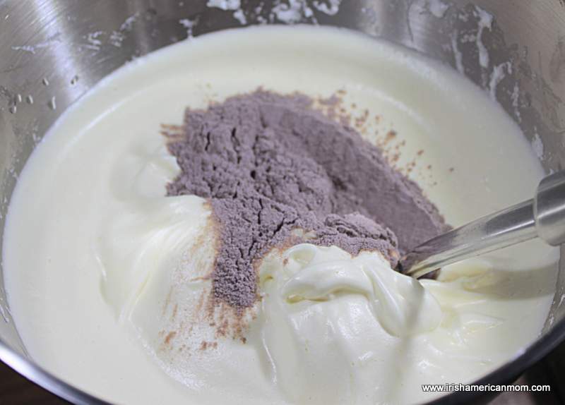 Adding flour and cocoa powder to whipped eggs and sugar