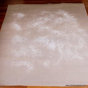 A close up of parchment paper with sugar