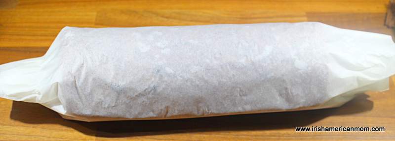 A cake rolled up in parchment paper