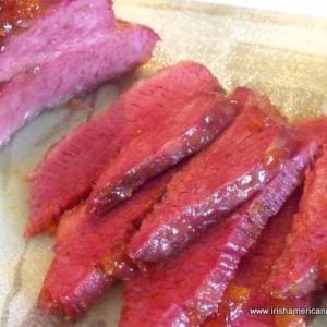 Apricot-Glazed-Corned-Beef-Sliced | Irish American Mom Slices of apricot glazed corned beef on a cutting board