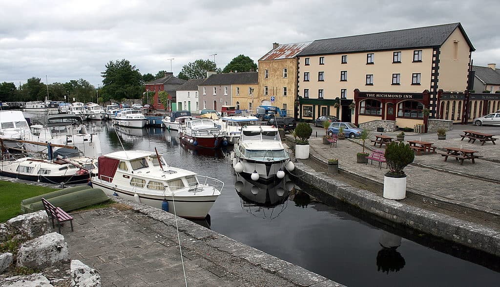 Boats beside a pier and old stone buildings
