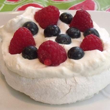 Individual pavlovas with fruit and fresh cream