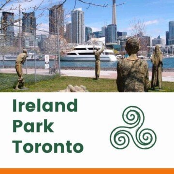 Statues in a city waterfront bark over a text banner