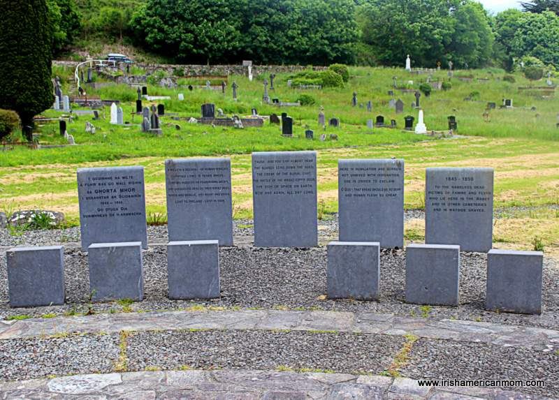 Five memorial stones with seats at the Famine Burial Pits Memorial in Skibbereen | Irish American Mom Stone memorials beside the mass Famine grave in Skibbereen