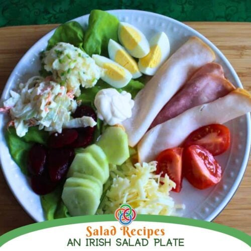 A traditional Irish salad plate with ham, boiled eggs, potatoes, coleslaw, beetroot, cucumber, tomatoes, and cheese arranged on a white plate with text banner.