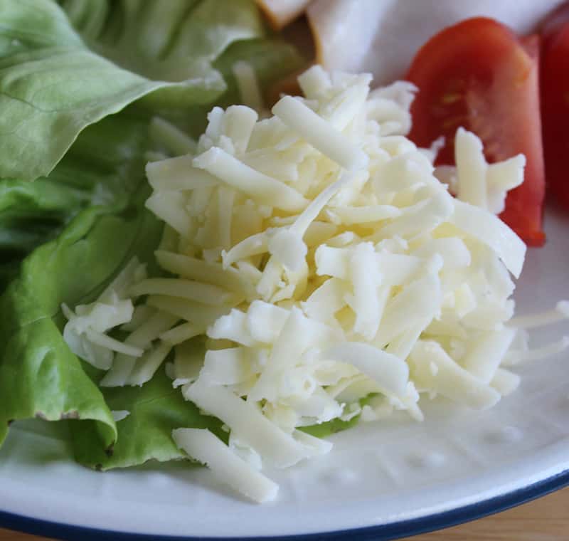 Grated Irish white cheddar cheese on an Irish salad plate | Irish American Mom Grated white cheddar cheese is served as a part of an Irish salad