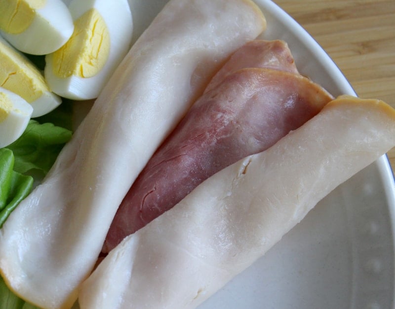 Slices of deli turkey and ham for an Irish salad | Irish American Mom Rolled deli turkey and ham on an Irish pub salad.