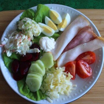 Lettuce, eggs, meat, tomato, cheese, cucumber, beetroot,coleslaw and potato salad with mayonnaise on an Irish salad plate.