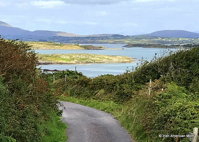 Looking toward the main land from a boreen on Sherkin Island | Irish American Mom A body of water and a narrow road