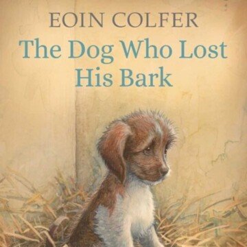 A dog sitting in straw with text overlay