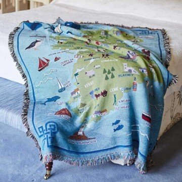 A blanket on the end of a bed