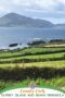 Scenic view of the Beara Peninsula coastline with green fields, stone fences, and the Atlantic Ocean under a cloudy sky in County Cork, Ireland.