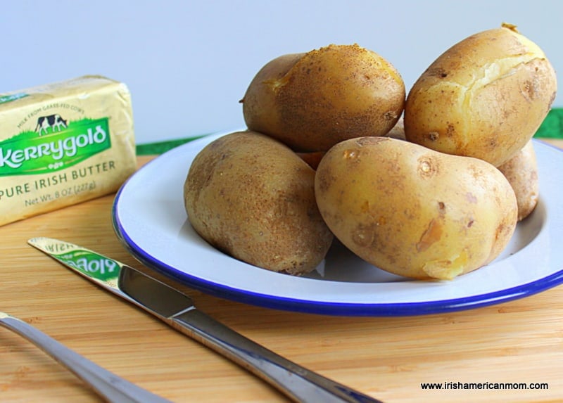Boiled floury Irish potatoes with split skins on a plate