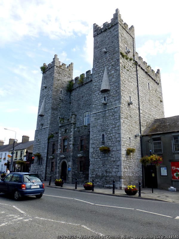 A large stone keep with two tall pillars at the side with a castellated roof top