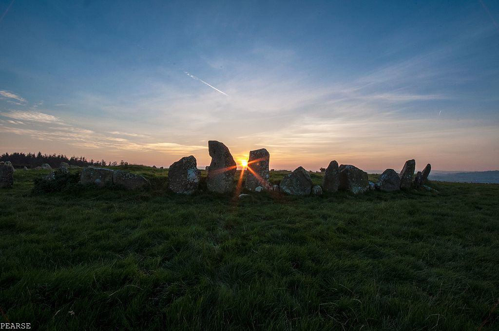 Beltany Stone Circle near Rahpoe County Donegal as the sun sets in the evening | Irish American Mom The sun shining through the stones of the Beltany Stone Circle in Ireland