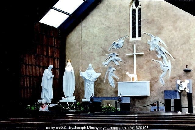 Gable end of the church in Knock with white statues and an altar as a shrine to the Virgin Mary.