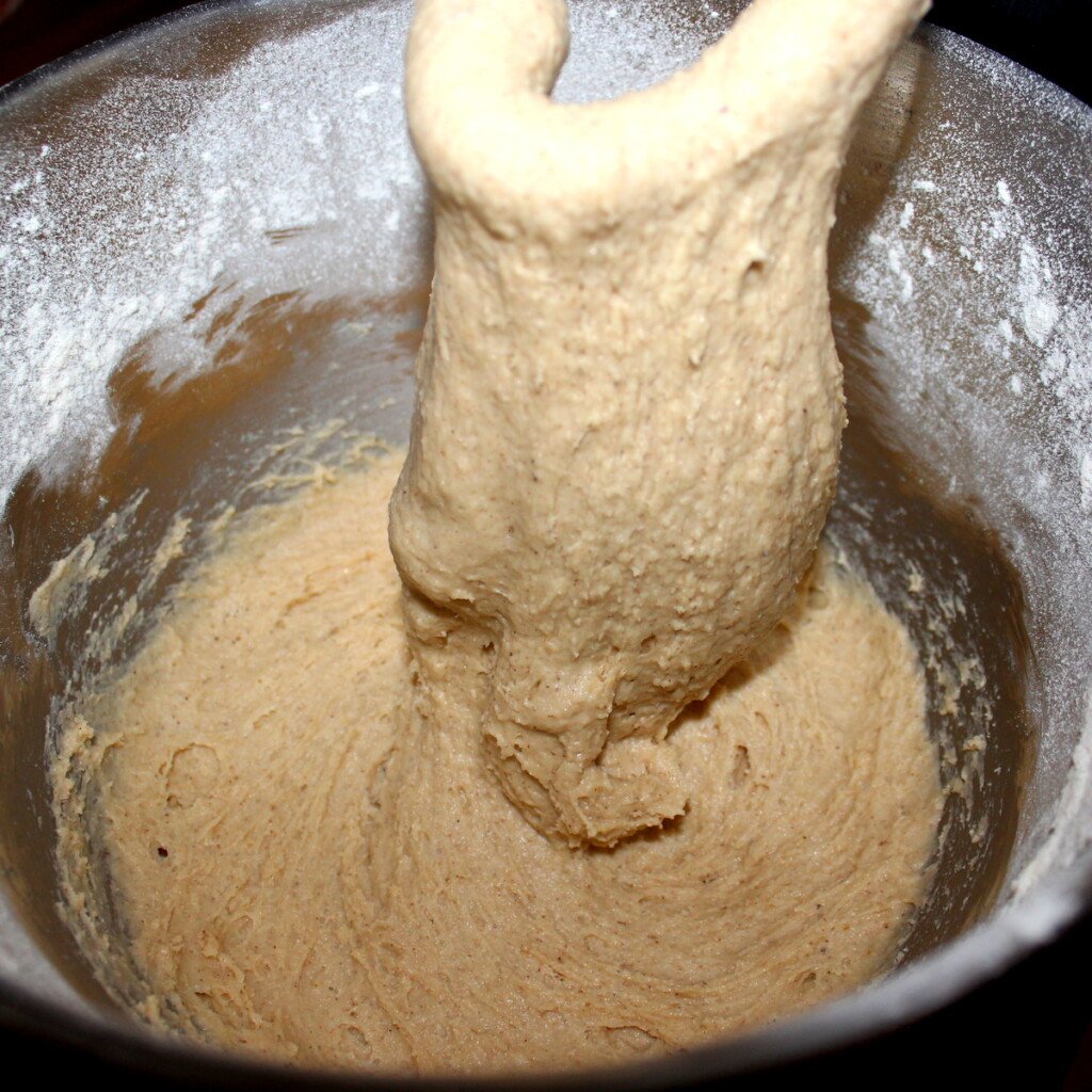 Dough dripping off a dough hook of an electric mixer