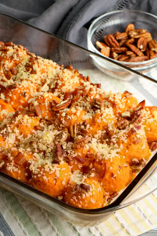 Sweet potato casserole with a pecan, panko and bacon topping | Irish American Mom Pecan and panko topped sweet potato casserole in a glass casserole dish
