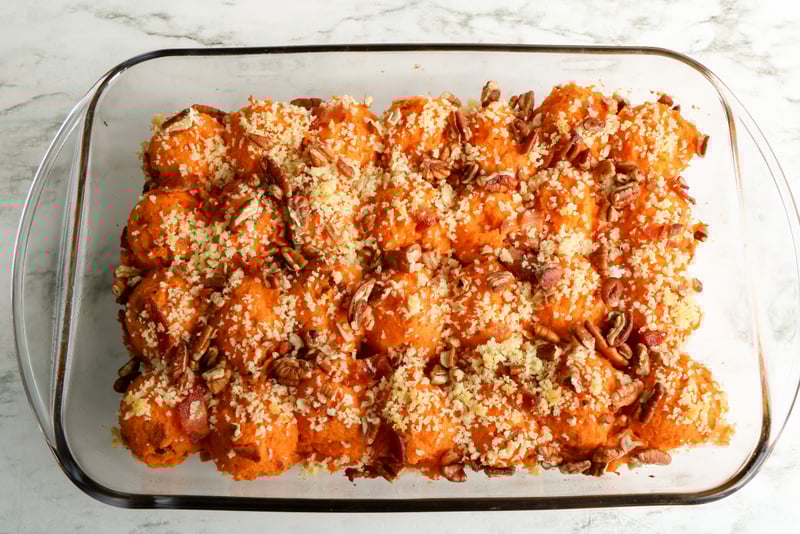 Twice Baked Sweet Potato Casserole with Bacon ready to be put in the oven | Irish American Mom Mashed sweet potato in a casserole and topped with panko, bacon bits and chopped pecans