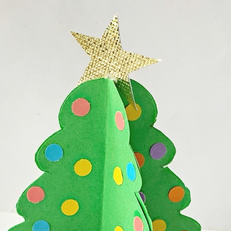 A golden star on top of a green paper Christmas tree | Irish American Mom A star on top of a green paper Christmas tree
