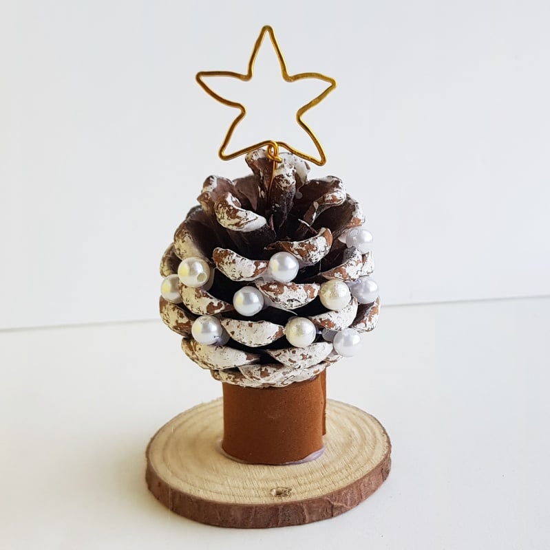 A golden star on top of a snowy pine cone homemade Christmas tree ornament | Irish American Mom A golden star on top of a pine cone Christmas tree