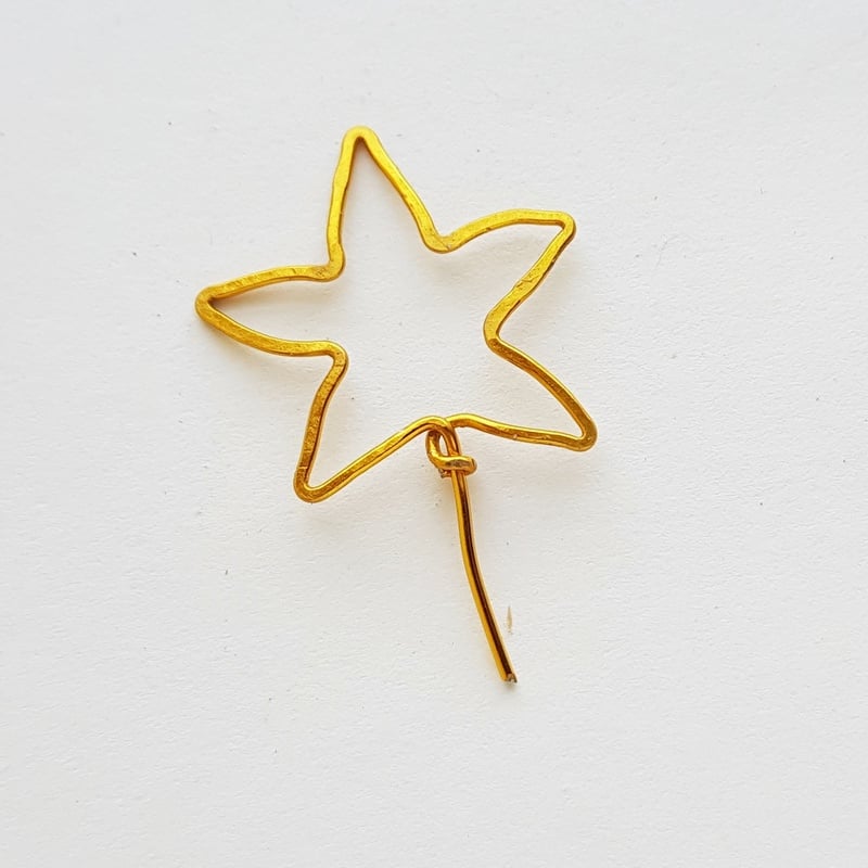 A golden wire star for the top of a handmade Christmas tree ornament | Irish American Mom Golden wire star for craft projects on a white background