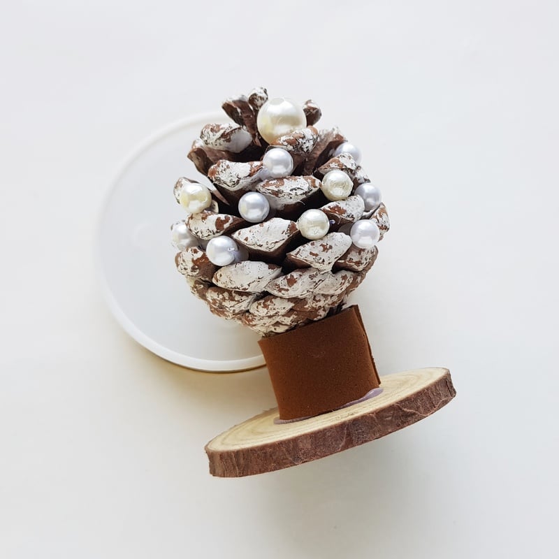 Beads glued to a snowy pine cone to create a handmade Crhistmas tree | Irish American Mom White beads glued to a pine cone Christmas tree craft