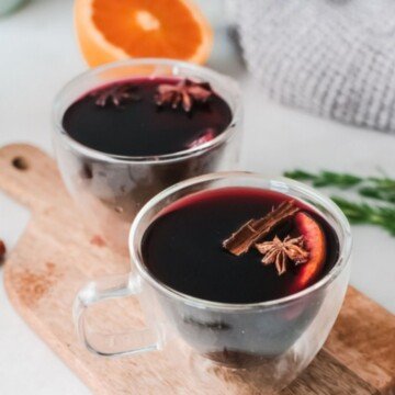 Red mulled with with cinnamon and star anise in glass cups on a cutting board