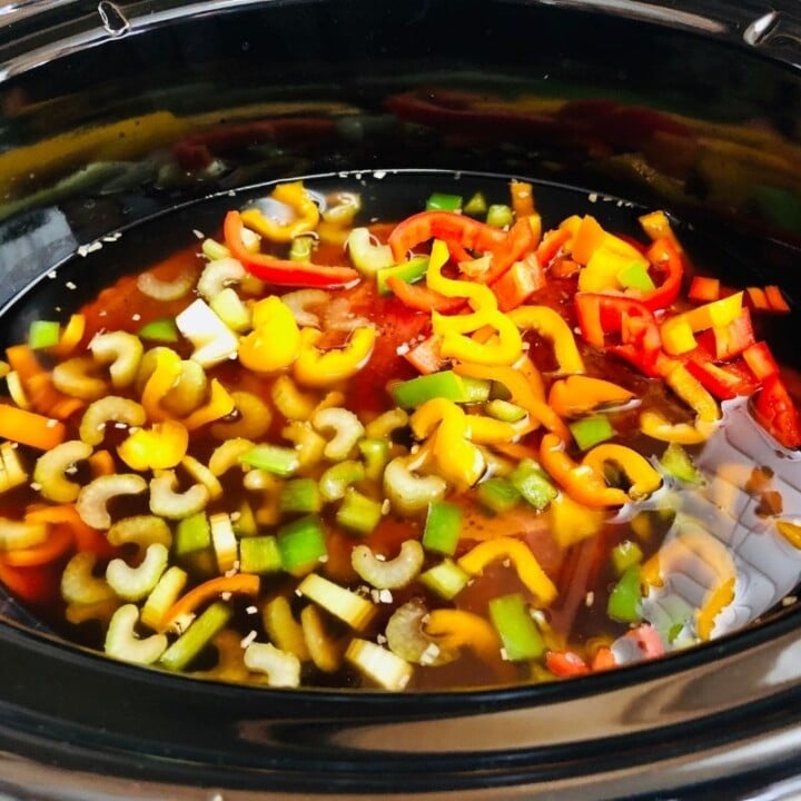 Beef barley stew in a crock pot | Irish American Mom Vegetables, beef and stock in the bowl of a slow cooker