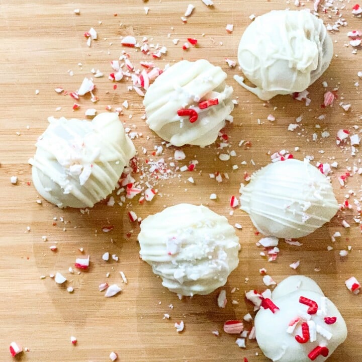 Cake Truffles with White Chocolate and Peppermint shavings | Irish American Mom White chocolate truffles on a cutting board with peppermint candy shards