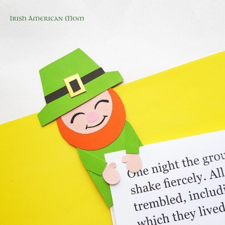 Paper leprechaun bookmark attached to a book page
