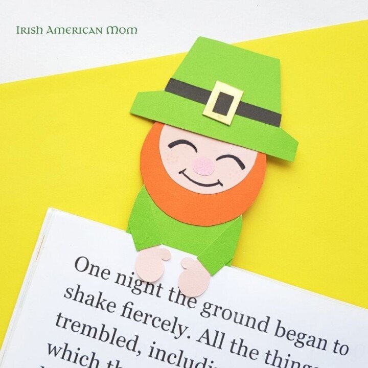 Homemade Paper leprechaun bookmark craft | Irish American Mom A green leprechaun paper craft bookmark on a page