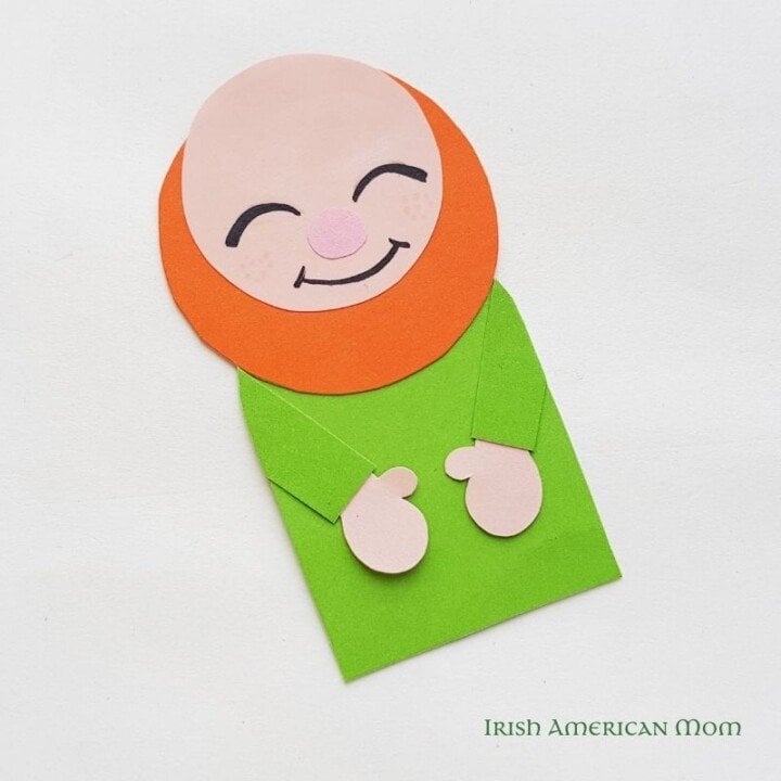 Paper leprechaun with marker face for a bookmark | Irish American Mom Black marker face marks on a paper cut out leprechaun
