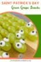 Green grape snakes on skewers with candy eyes displayed on a wooden serving board for a Saint Patrickโs Day party in a text graphic.