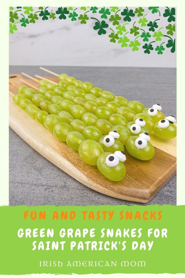 Saint Patrick's Day Snake Snacks | Irish American Mom Green grapes on skewers to look like snakes on a graphic with text banner and shamrocks