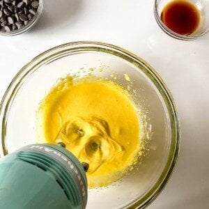 Whisking eggs and sugar with an electric mixer