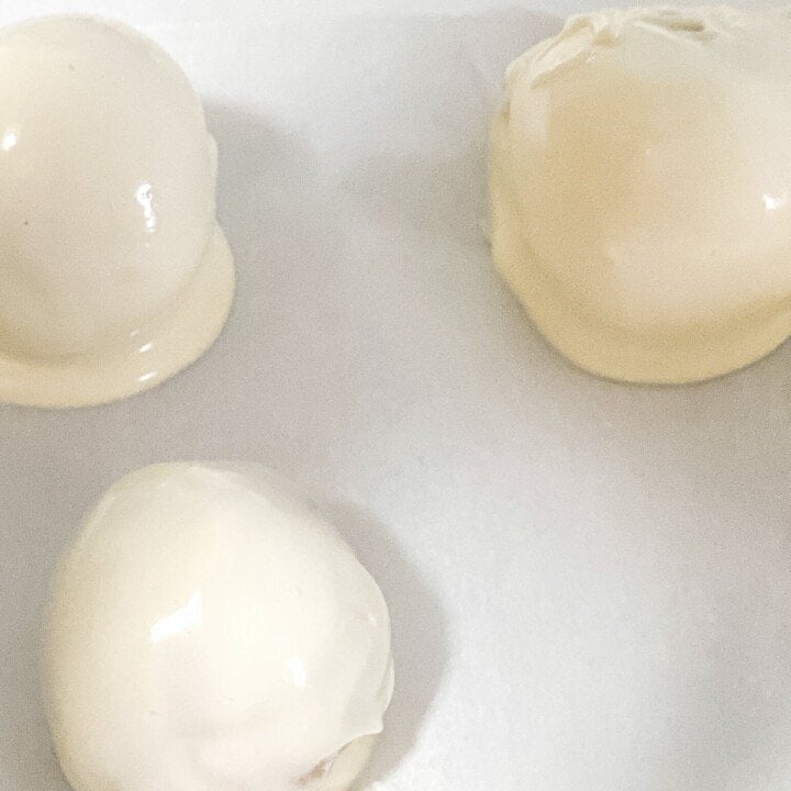 White chocolate covered truffles | Irish American Mom White chocolate covered cake truffles on parchment paper