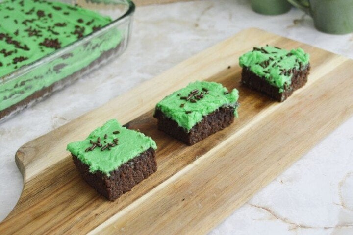 Brownies with green frosting for Saint Patrick's Day | Irish American Mom Three Irish brownies with green frosting on a cutting board